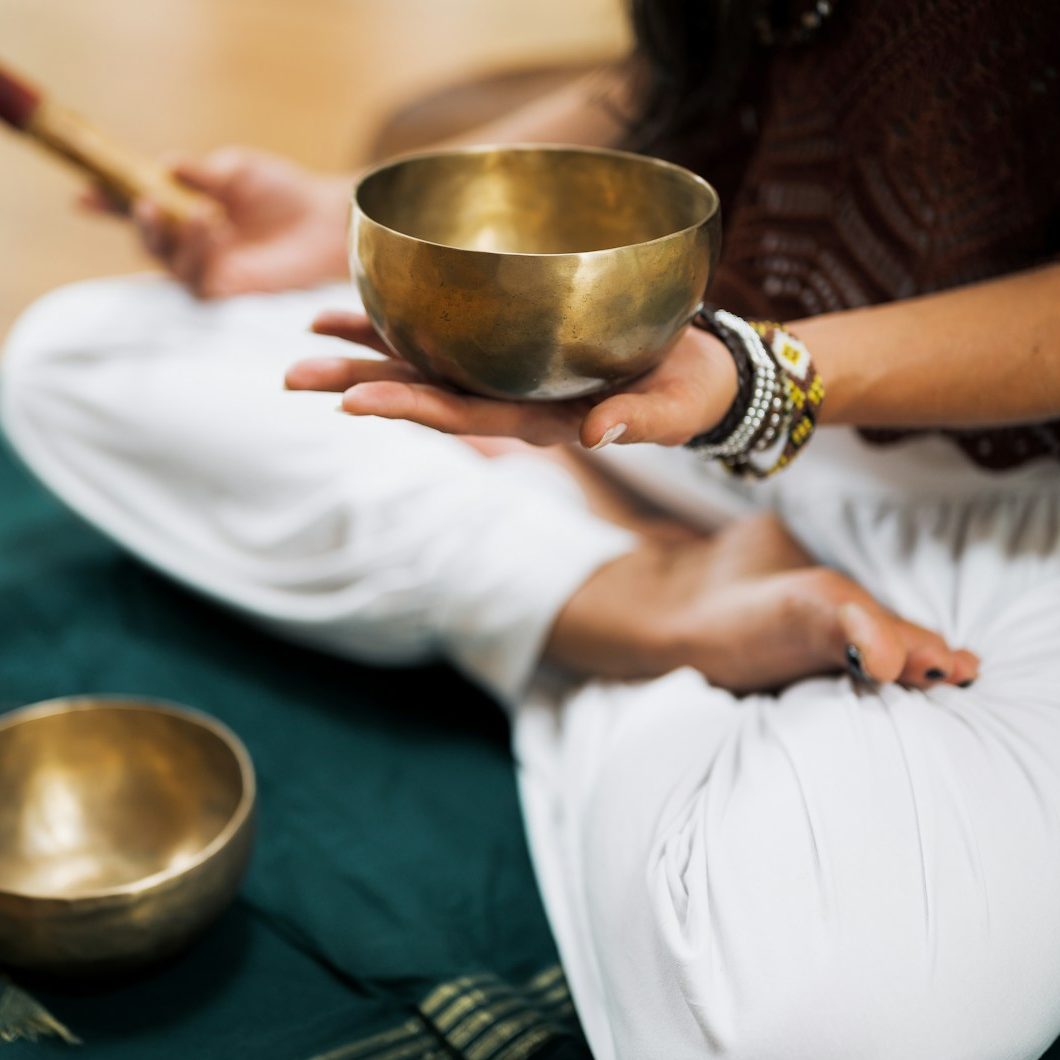 person in white dress shirt holding brown wooden chopsticks